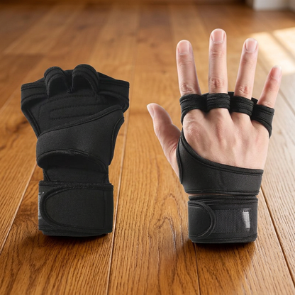 Pair of black fingerless weightlifting gloves with wrist wrap straps on a hardwood floor, front and back view.